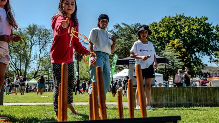Children playing a game on a green lawn