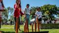 Children playing a game on a green lawn