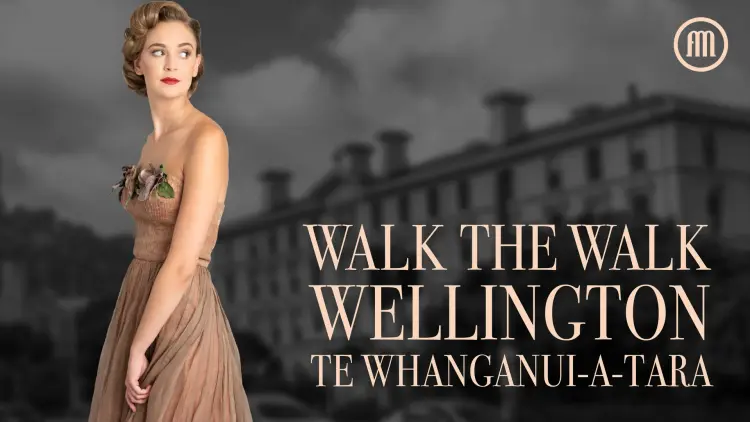 A woman in a dress standing next to a building