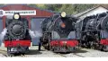 Three black and red steam trains 