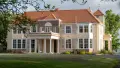Exterior shot of grand historic homestead with pillars.