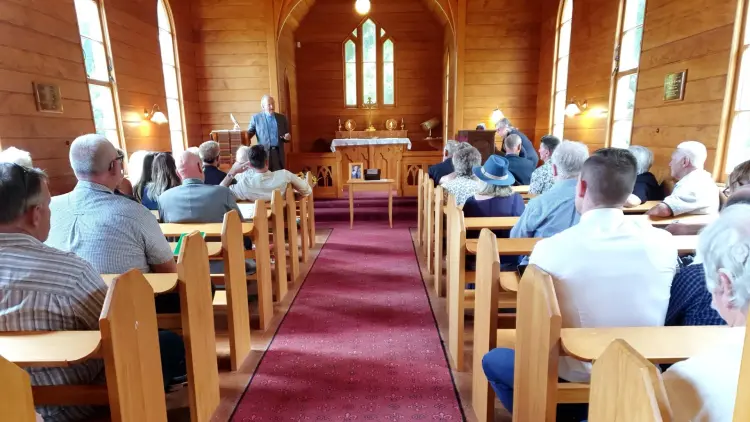 Interior shot of church with people sitting on pews