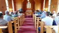 Interior shot of church with people sitting on pews