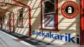 Paekakariki station painted yellow and red, logo for Paekakariki Station Museum on the top right