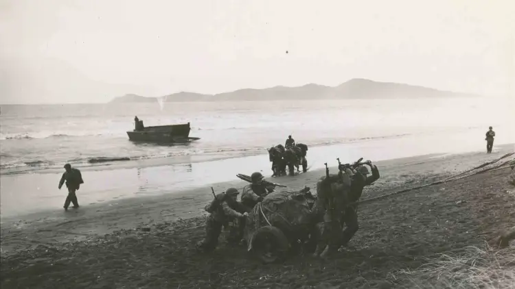 Historic photo of US marines arriving by boat on a beach with Kāpiti Island in background