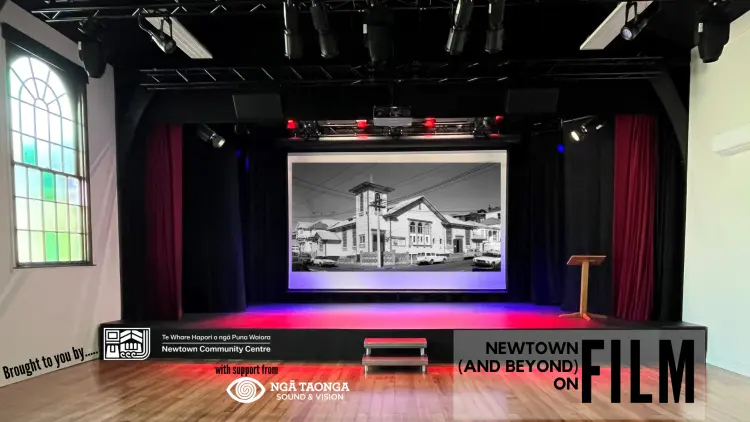 A stage with a black and white picture projected on the screen