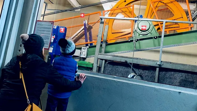 Two people looking up at a cable car part