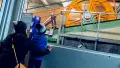 Two people looking up at a cable car part