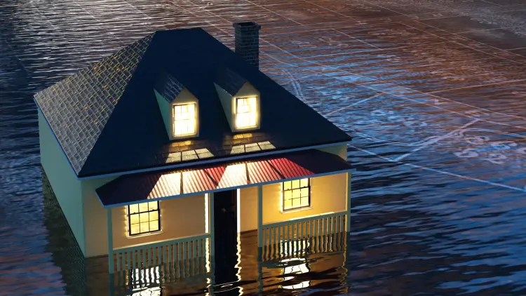 Cottage with lights on submerged in flood water