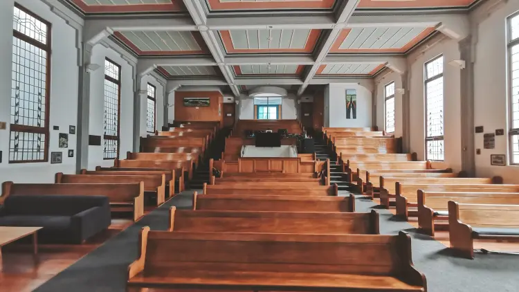 Interior shot of church with pews and high roof
