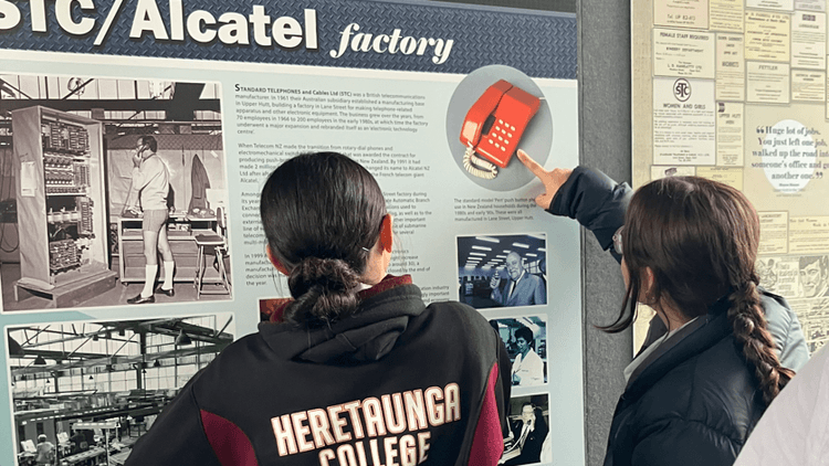 Heretaunga College students examine a visual display of the Upper Hutt: City of Industry exhibition.