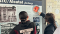 Heretaunga College students examine a visual display of the Upper Hutt: City of Industry exhibition. 