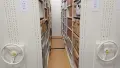 Interior shot of archive storage racks with boxes.